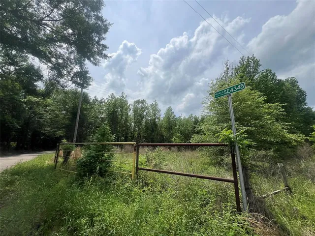 a backyard of a house with lots of green space and lake view