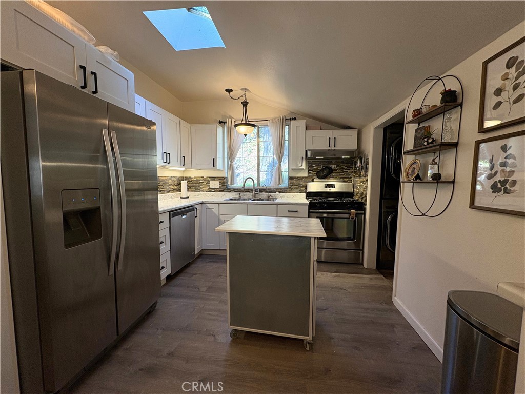 36750 Hilltop Road Yucaipa, CA 92399 - Photo 8 of 27 a kitchen with stainless steel appliances granite countertop a refrigerator and a stove