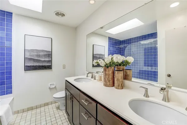 a bathroom with a sink double vanity and a toilet
