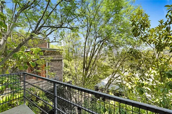 a view of a balcony with a tree