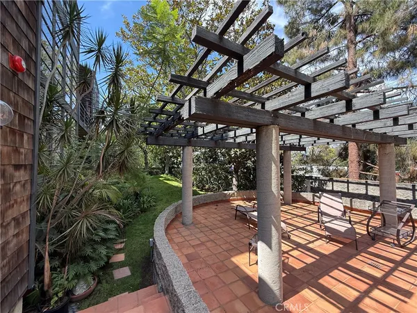a patio with glass top table and chairs