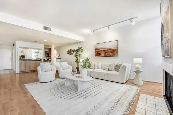 a living room with furniture and a lamp