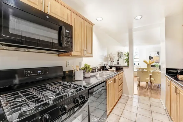 a kitchen with a stove a sink and a microwave
