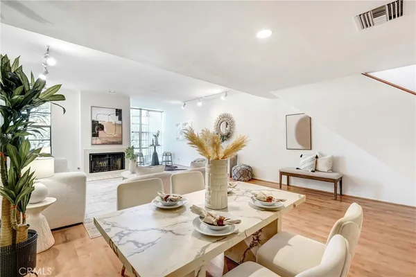 a living room with furniture fireplace and potted plants
