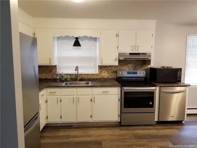 a kitchen with a stove and a refrigerator
