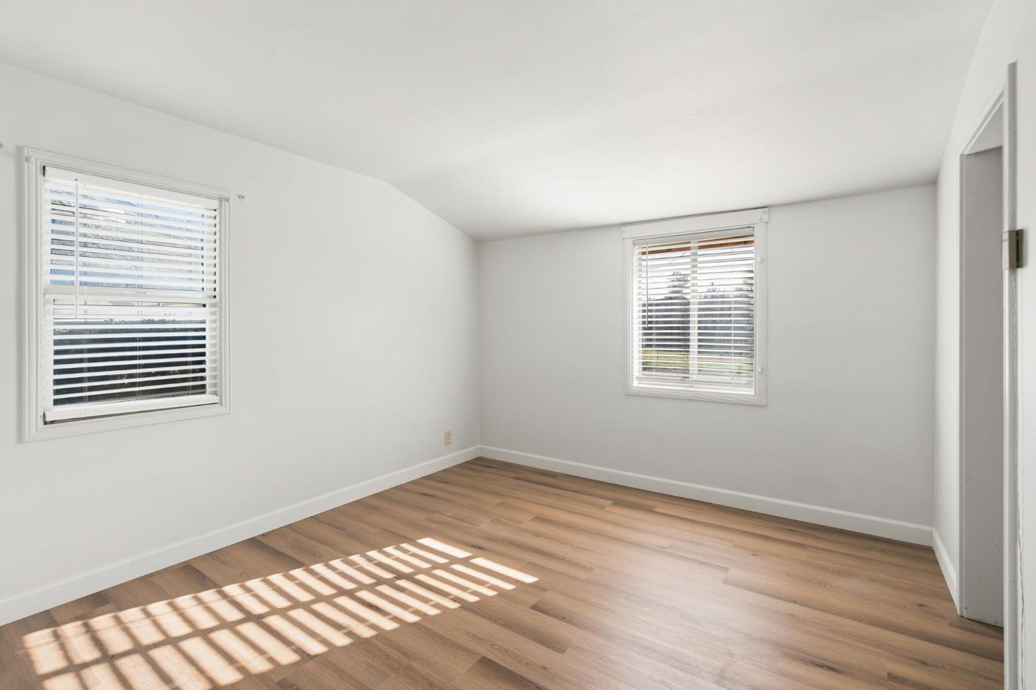 2315 Tyrolean Way Sacramento, CA 95821 - Photo 13 of 27 a view of an empty room with wooden floor and a window