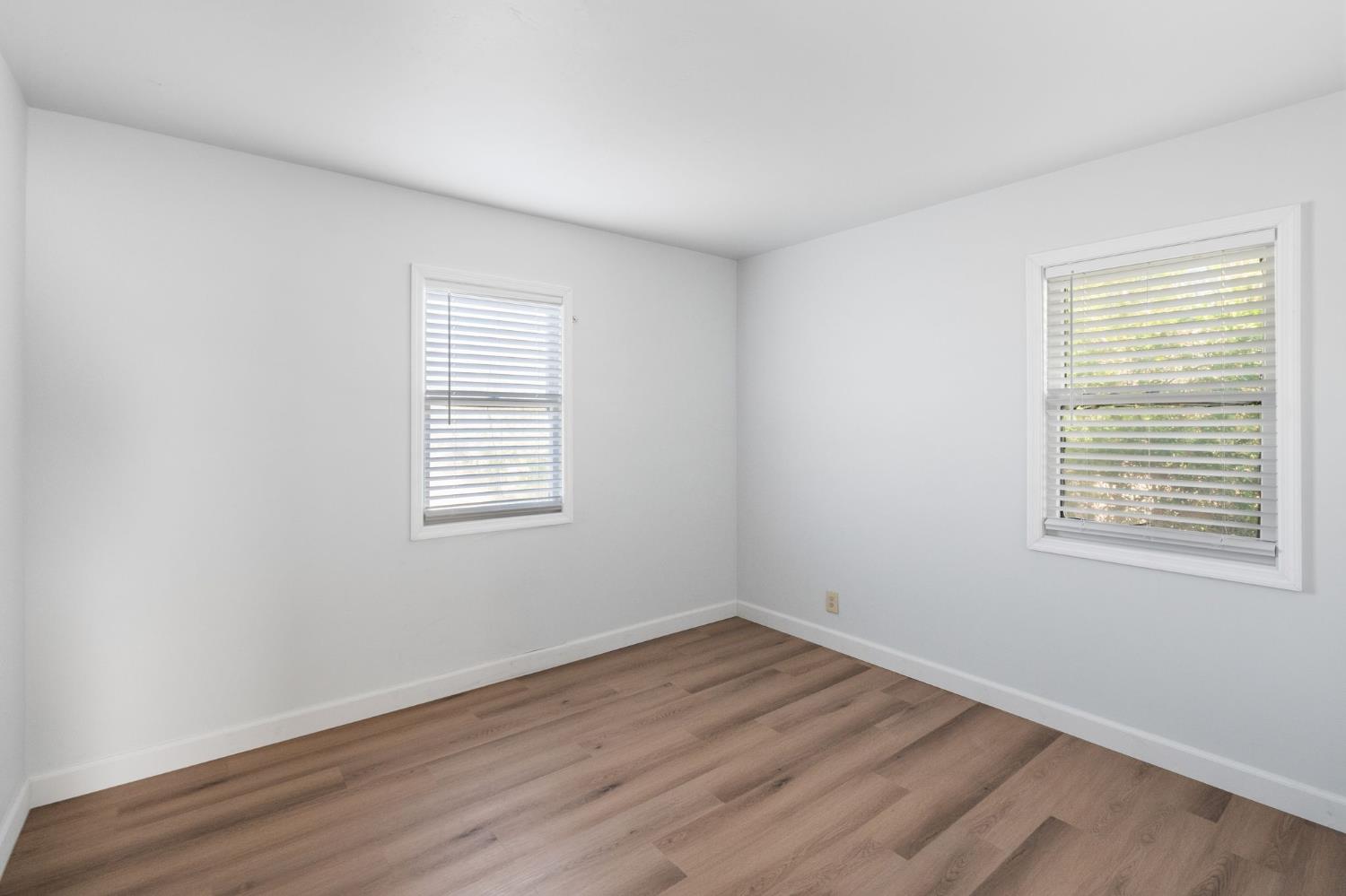 2315 Tyrolean Way Sacramento, CA 95821 - Photo 14 of 27 wooden floor in an empty room with a window