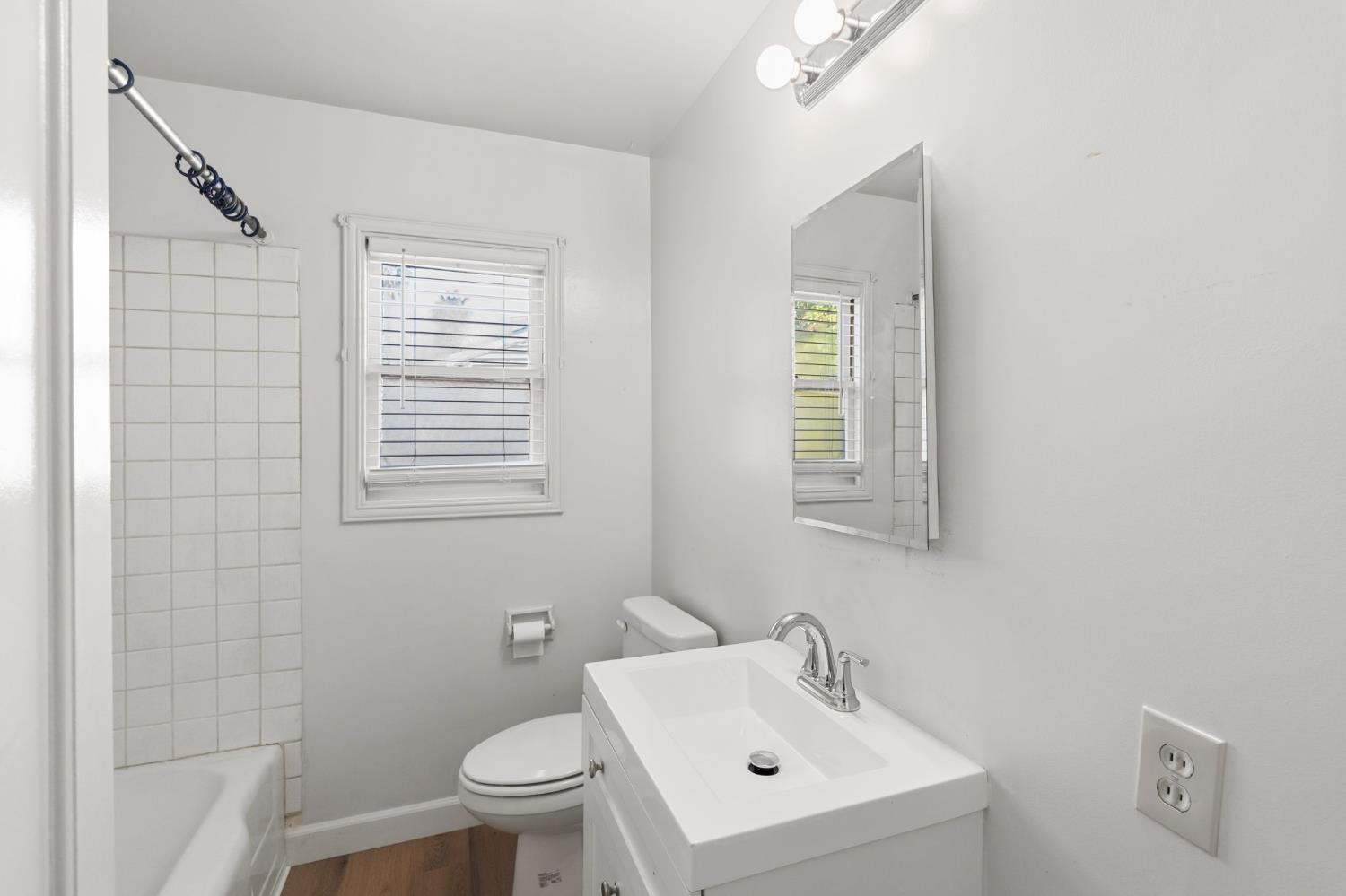 2315 Tyrolean Way Sacramento, CA 95821 - Photo 16 of 27 a bathroom with a sink a toilet and a mirror