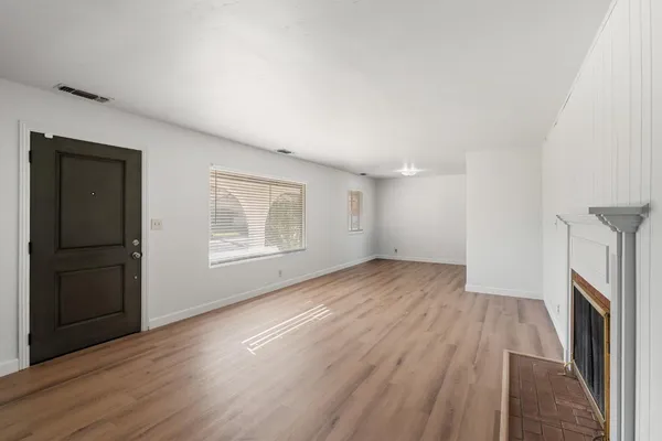 wooden floor in an empty room with a fireplace