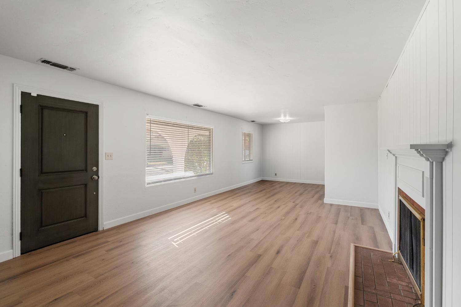 2315 Tyrolean Way Sacramento, CA 95821 - Photo 4 of 27 wooden floor in an empty room with a fireplace