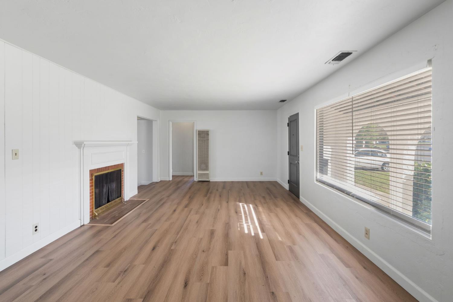 2315 Tyrolean Way Sacramento, CA 95821 - Photo 5 of 27 a view of empty room with wooden floor and fireplace