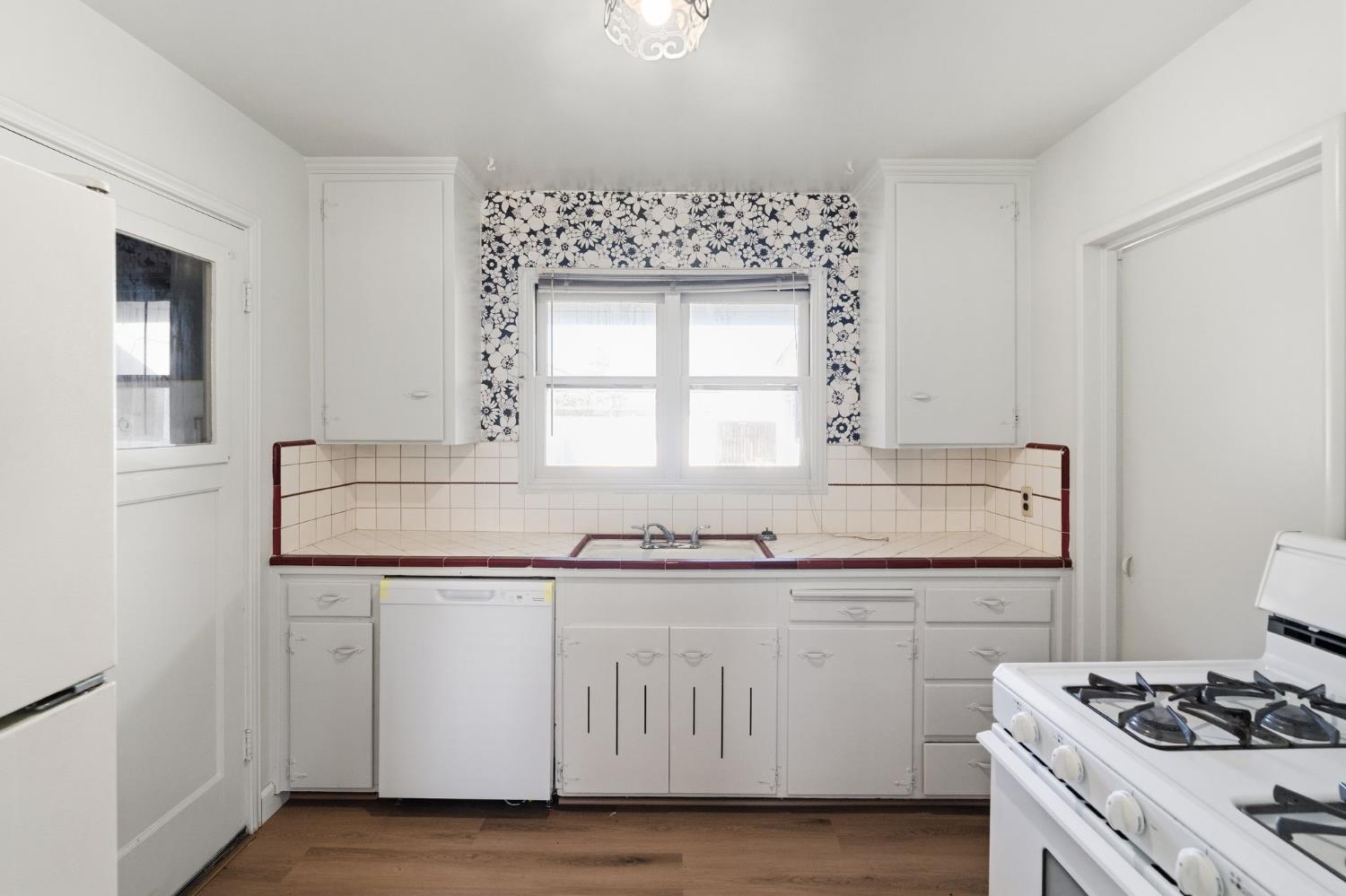 2315 Tyrolean Way Sacramento, CA 95821 - Photo 7 of 27 a kitchen with granite countertop a sink and cabinets