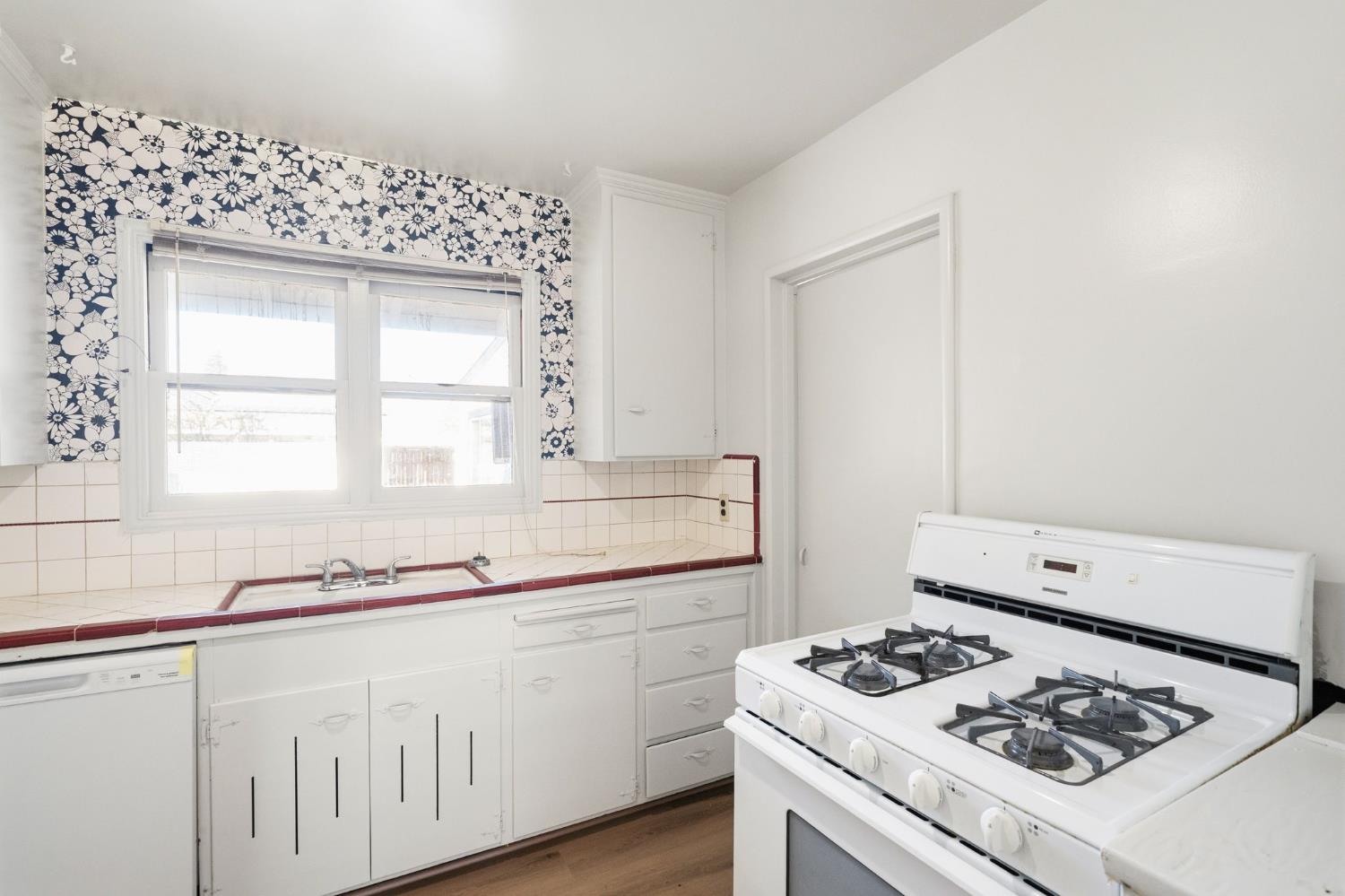2315 Tyrolean Way Sacramento, CA 95821 - Photo 8 of 27 a kitchen with white cabinets stove and sink