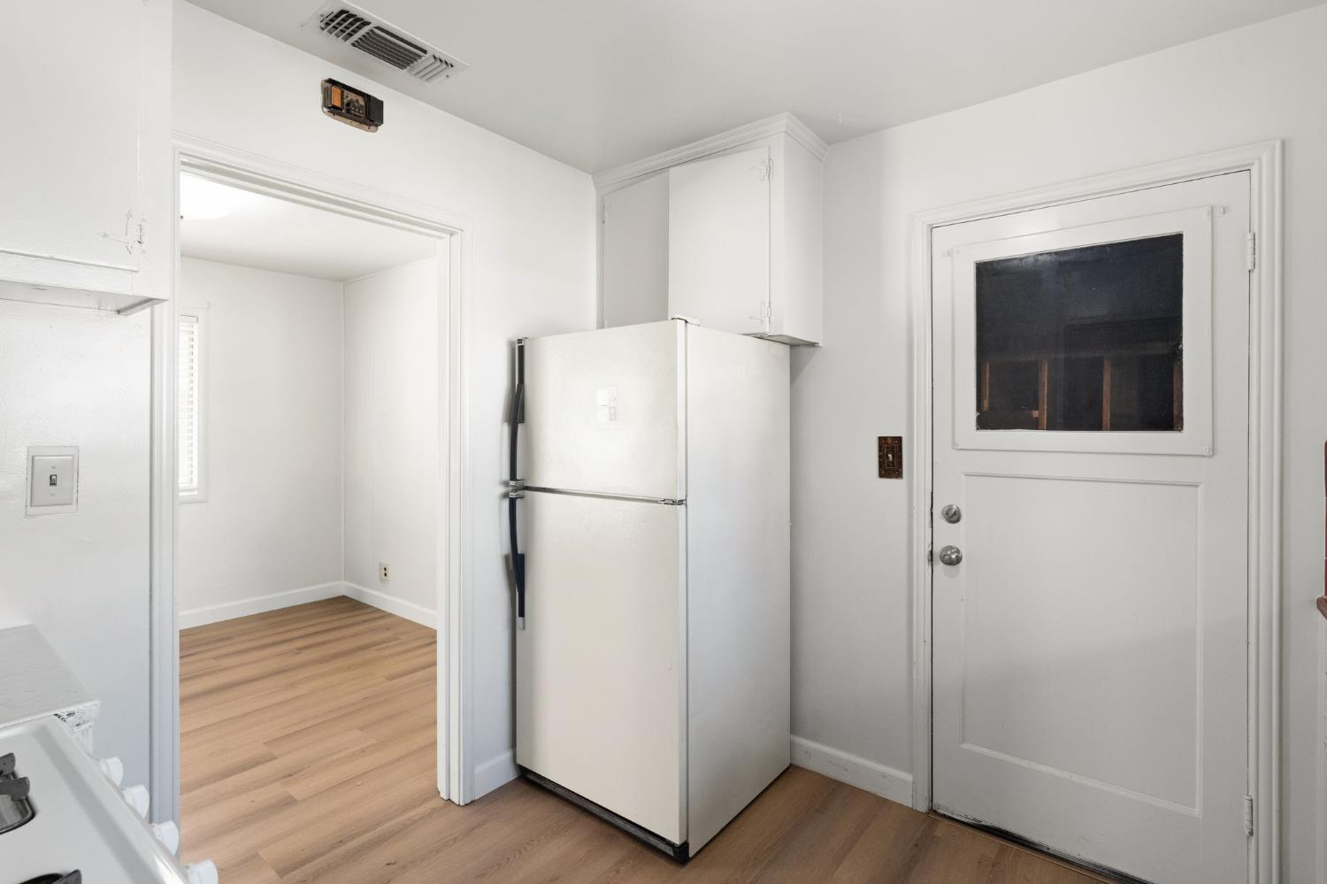 2315 Tyrolean Way Sacramento, CA 95821 - Photo 10 of 27 a view of a refrigerator in kitchen and wooden floor