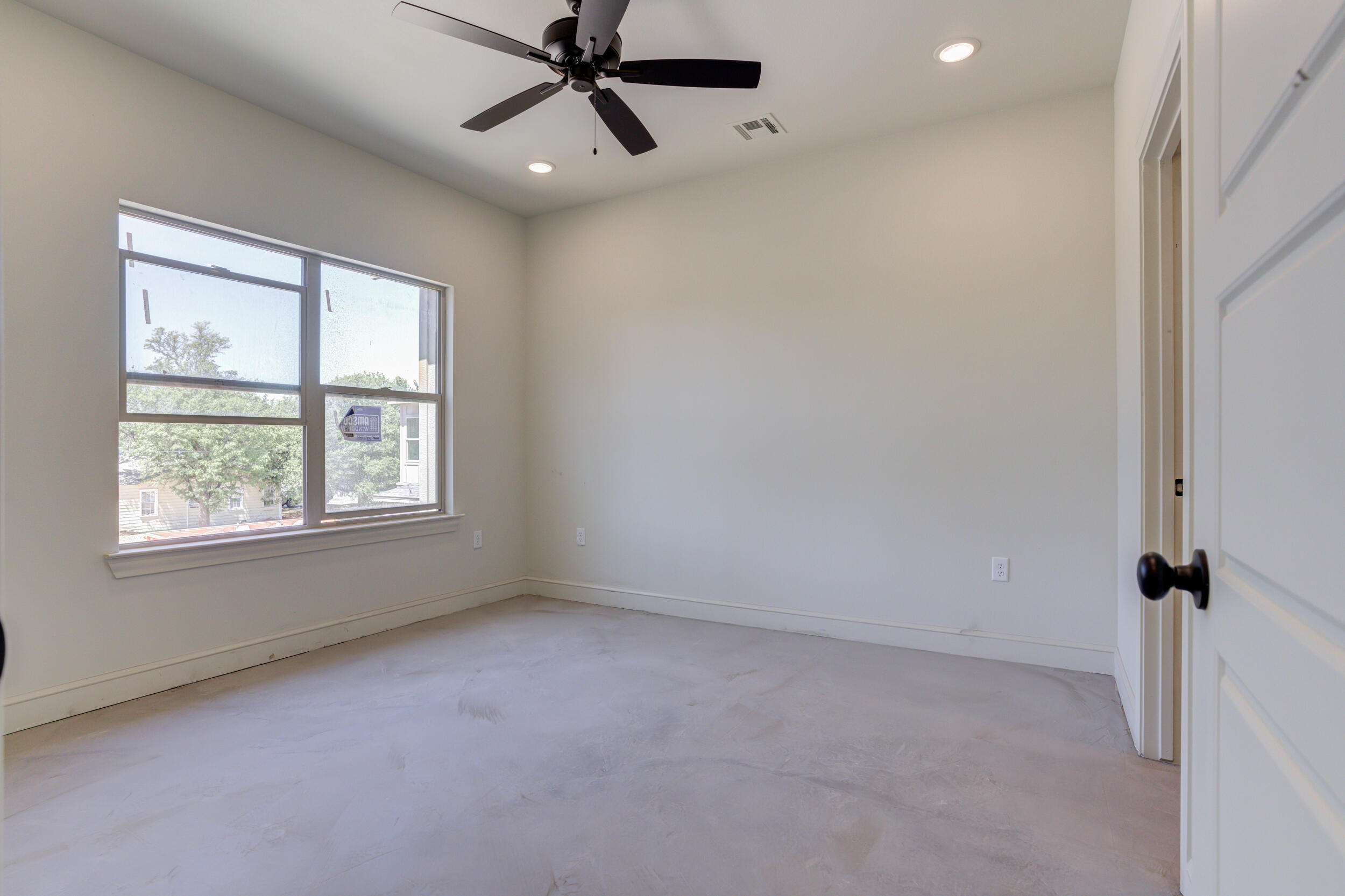 3421 24th Street Lubbock, TX 79410 - Photo 27 of 45 an empty room with a window and a fan