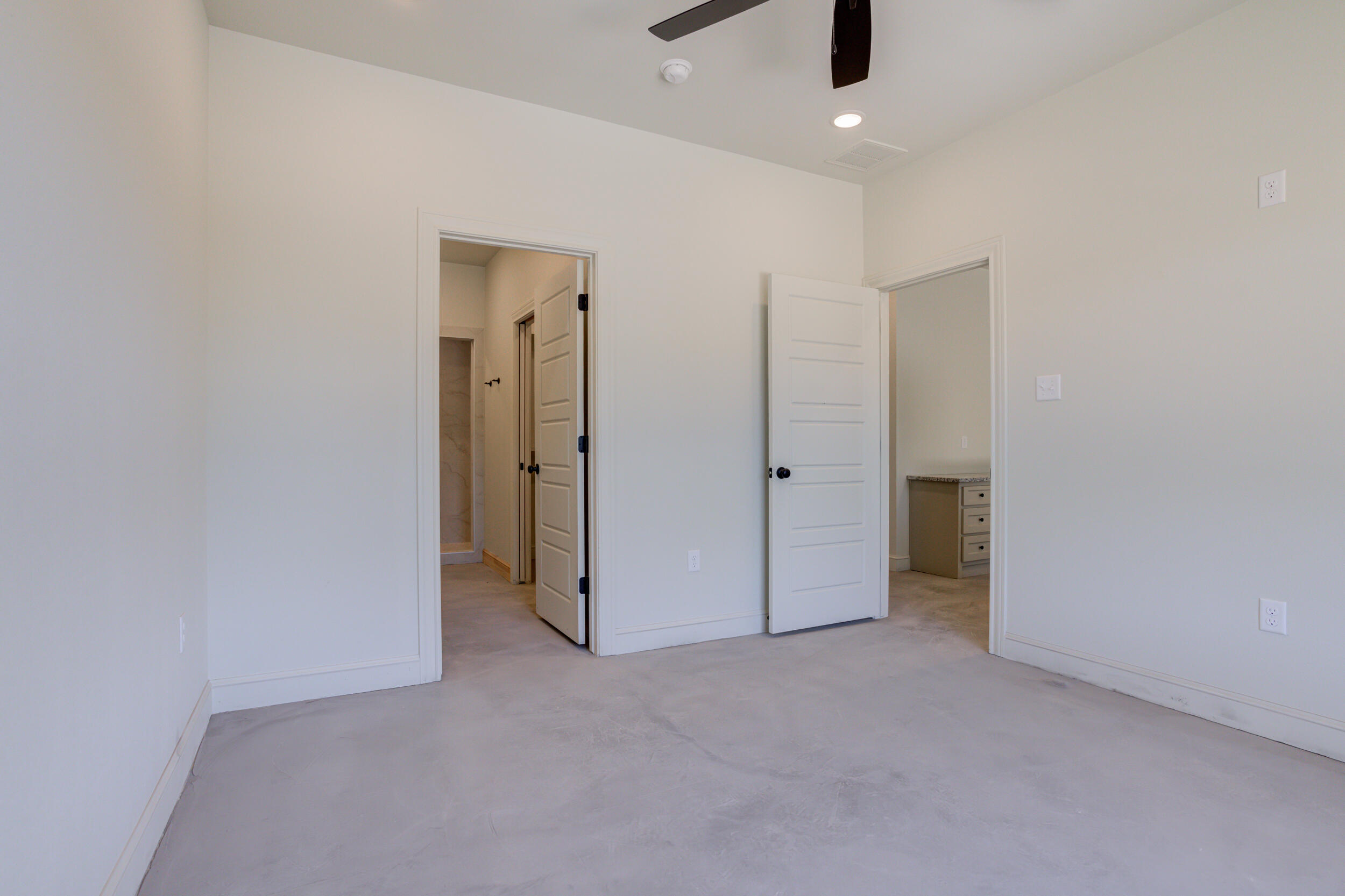 3421 24th Street Lubbock, TX 79410 - Photo 28 of 45 an empty room with closet and a chandelier fan