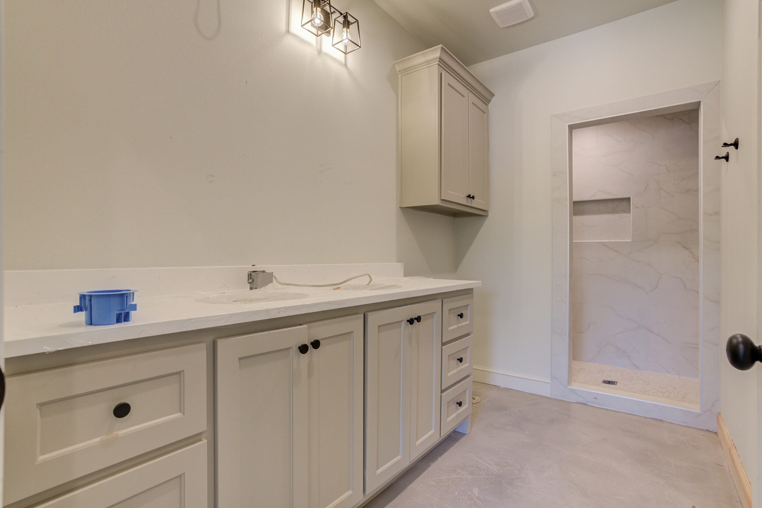 3421 24th Street Lubbock, TX 79410 - Photo 32 of 45 a spacious bathroom with a shower sink and mirror