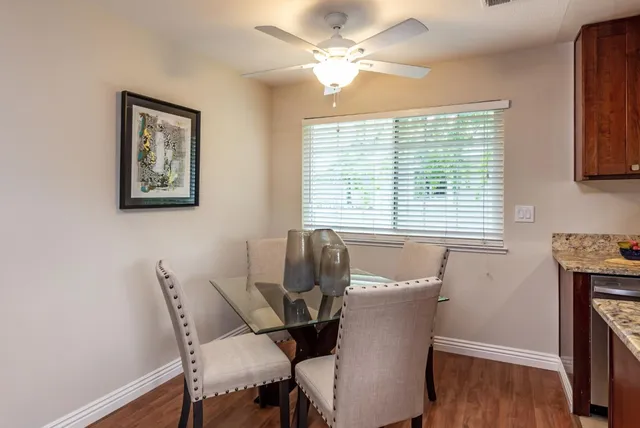a kitchen with stainless steel appliances granite countertop a sink a stove and a wooden cabinets