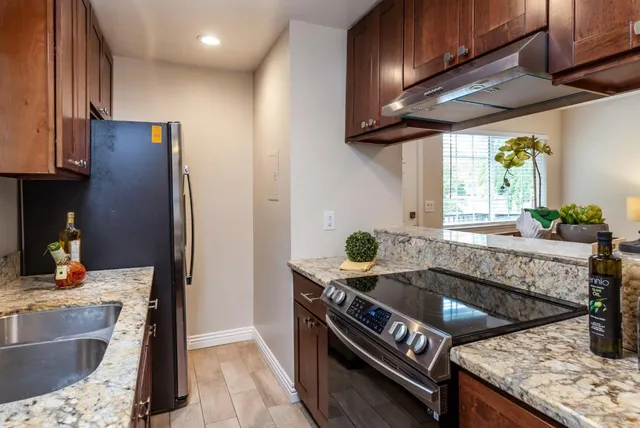 a kitchen with a sink stove and refrigerator