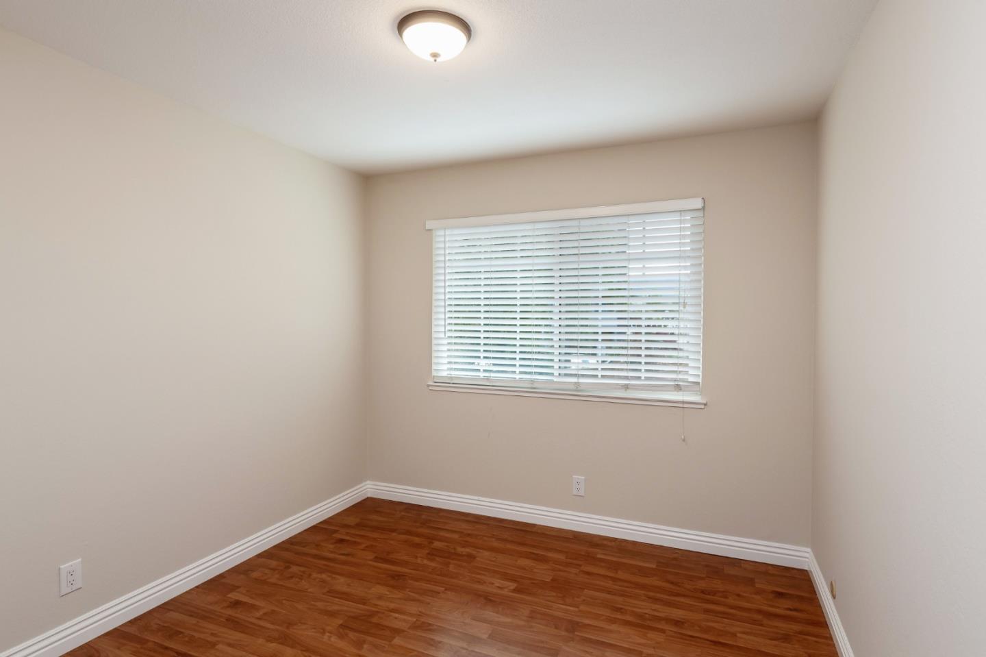 2323 Saidel Drive, Unit 4 San Jose, CA 95124 - Photo 20 of 23 an empty room with wooden floor and windows