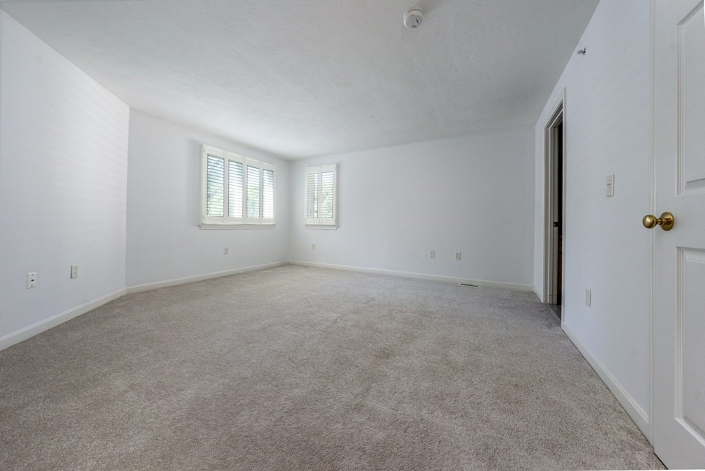 9 Executive Drive, Unit 286 Mashpee, MA 02649 - Photo 11 of 15 an empty room with windows