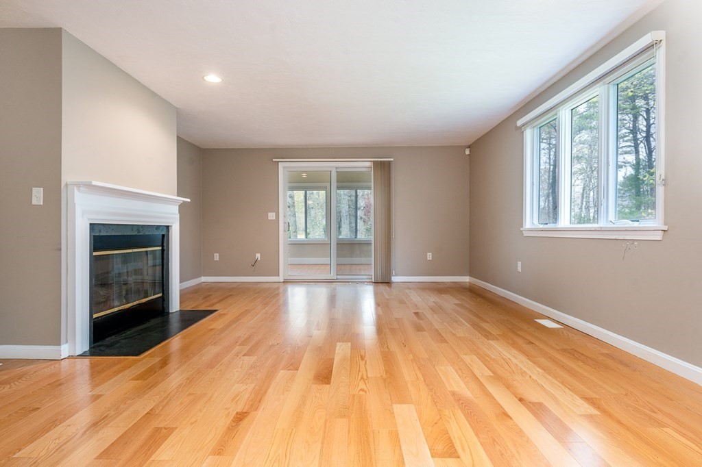 9 Executive Drive, Unit 286 Mashpee, MA 02649 - Photo 4 of 15 a view of an empty room with wooden floor and a window