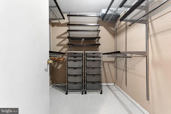 a view of walk in closet with empty racks