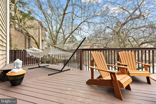 a view of a deck with couches next to a yard