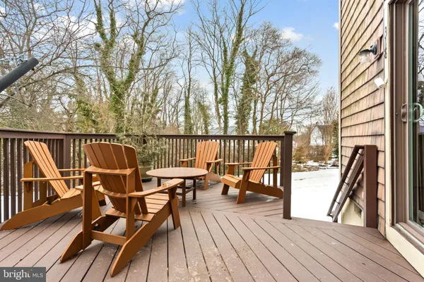 a view of a balcony with chairs and wooden floor