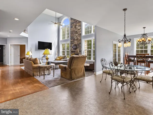 a living room with furniture a flat screen tv and a large window