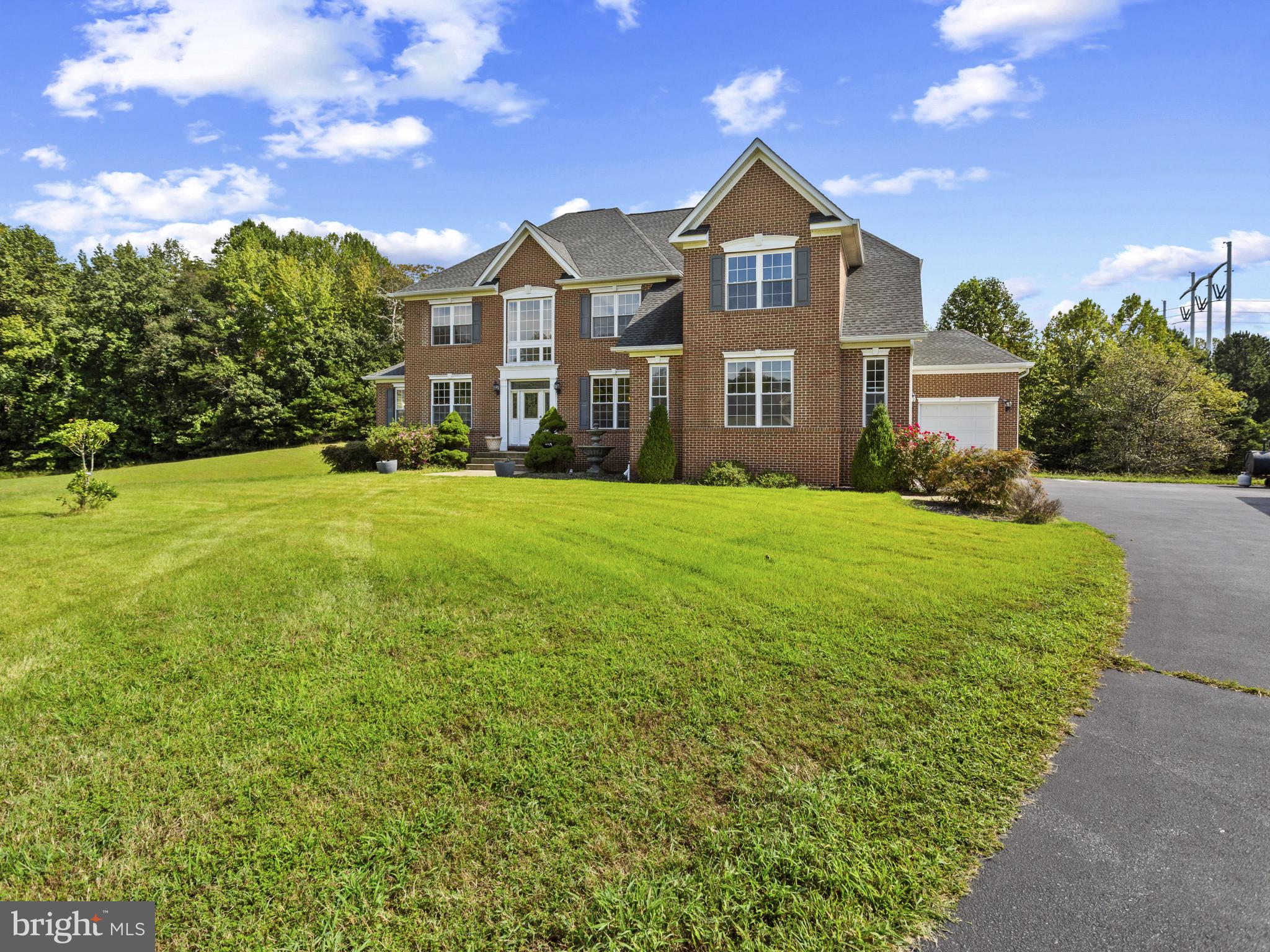 2045 Mount Pleasant Way Prince Frederick, MD 20678 - Photo 2 of 30 a front view of a house with a yard