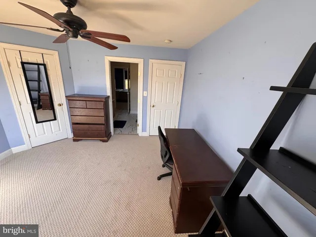 a view of a livingroom with furniture and staircase