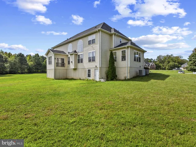 a front view of a house with yard and green space