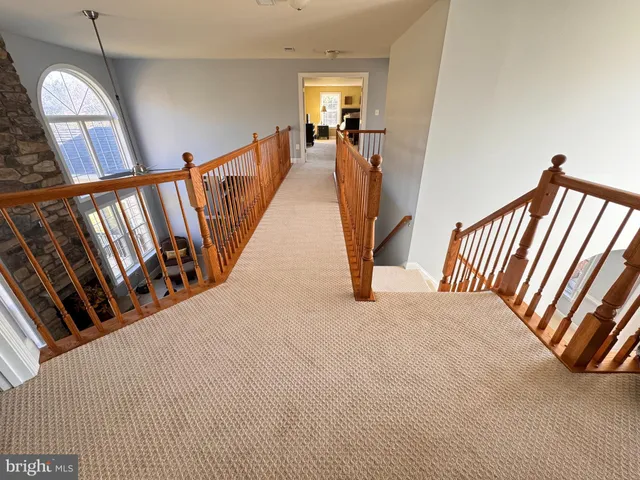 a view of staircase with rug
