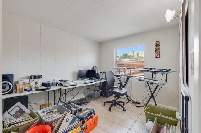 a view of a workspace with furniture and a window