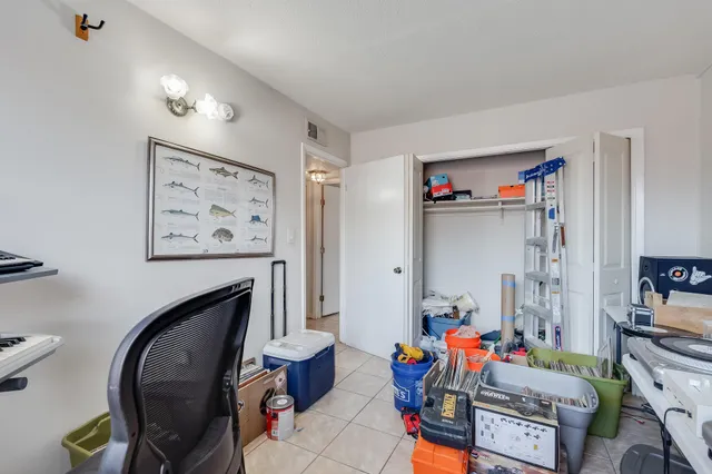 a living room with furniture and a baby crib