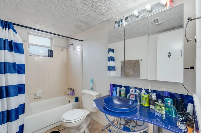 a bathroom with a toilet a sink and bathtub