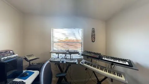 a view of a workspace with furniture and a window