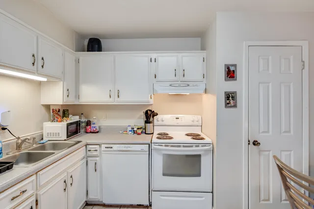 a kitchen with stainless steel appliances granite countertop a sink and cabinets