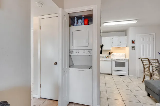 a kitchen with white cabinets and counter space