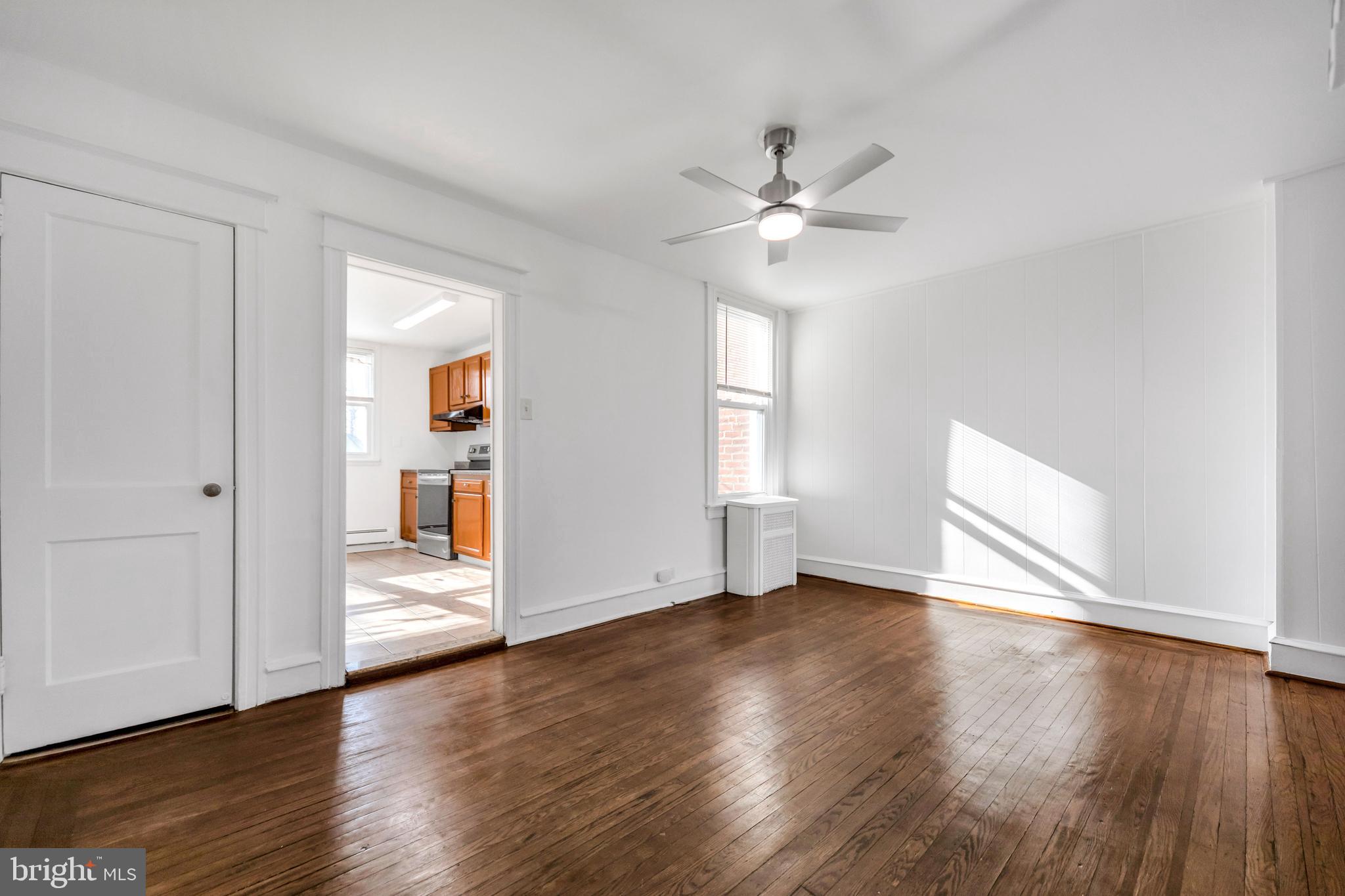 196 Springton Road Upper Darby, PA 19082 - Photo 9 of 27 a view of an empty room with window and wooden floor