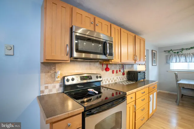 a kitchen with stainless steel appliances a refrigerator sink and cabinets