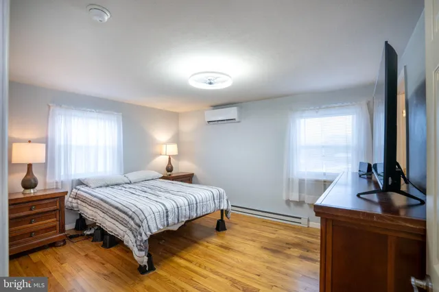 a bedroom with a bed and a night stand