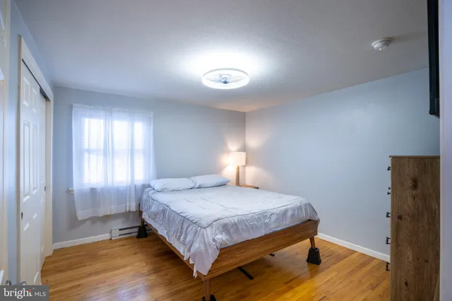 a bedroom with a bed and a a flat screen tv