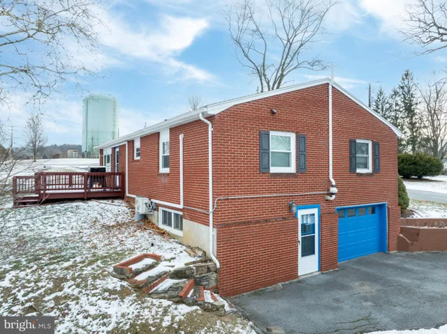 a brick house with a large tree