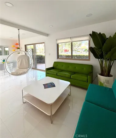 a living room with furniture and a potted plant