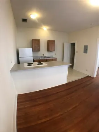 a view of kitchen with granite countertop a sink and a stove top oven