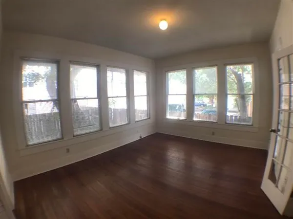 a bathroom with a tub a sink and a window
