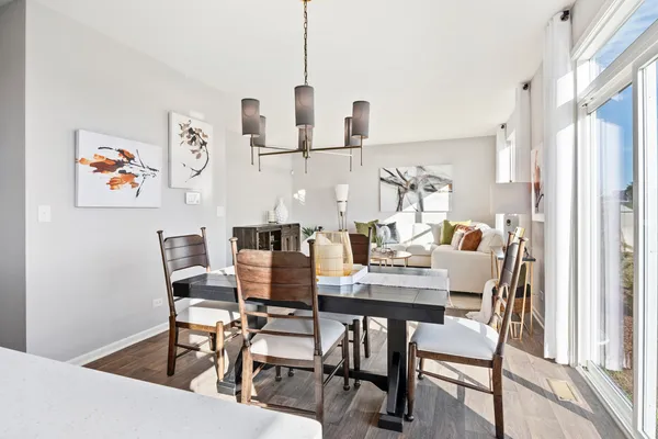 a dining room with furniture and wooden floor