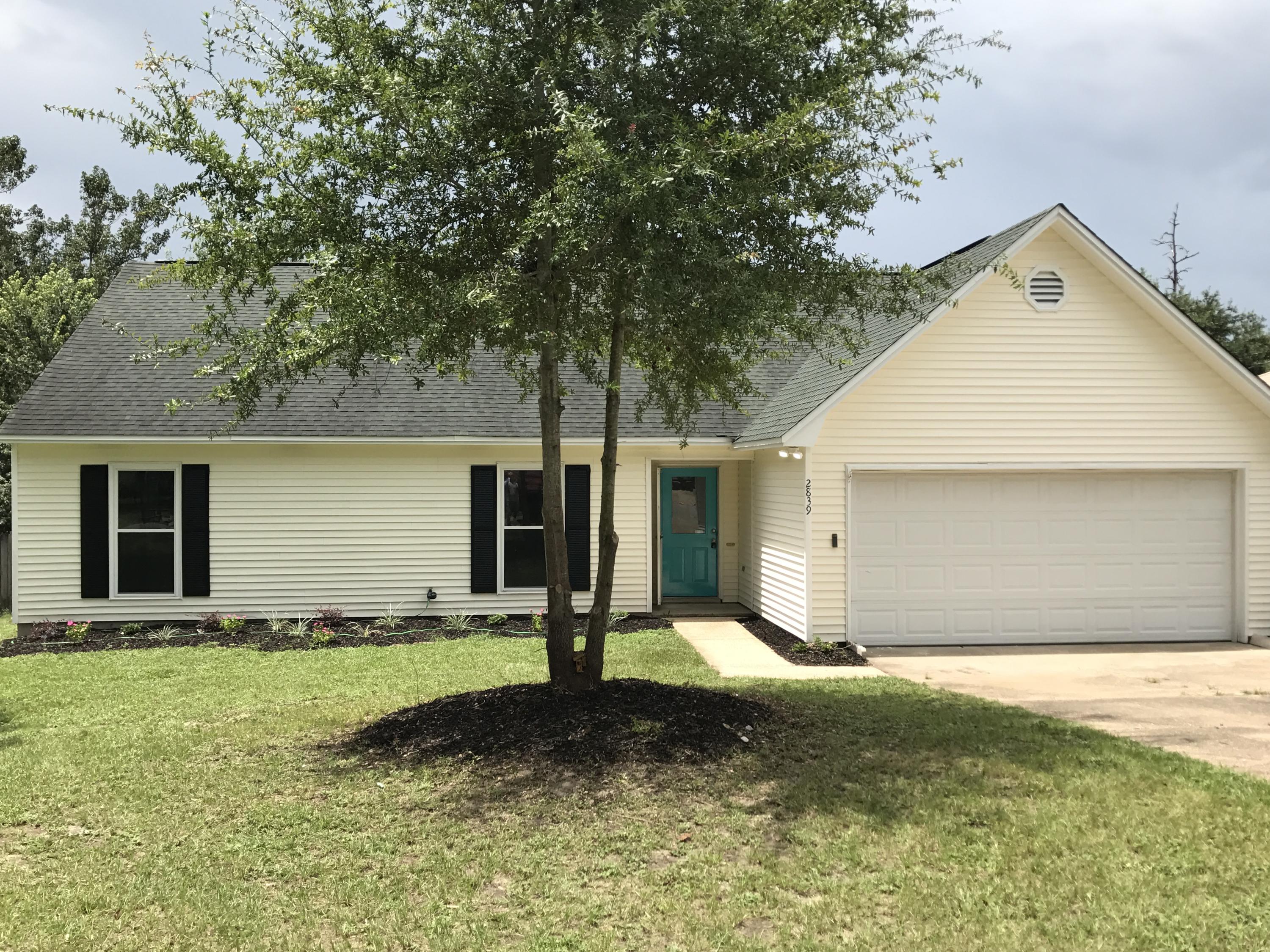 2839 Old Mill Way Crestview, FL 32539 - Photo 17 of 28 a front view of a house with a yard and garage